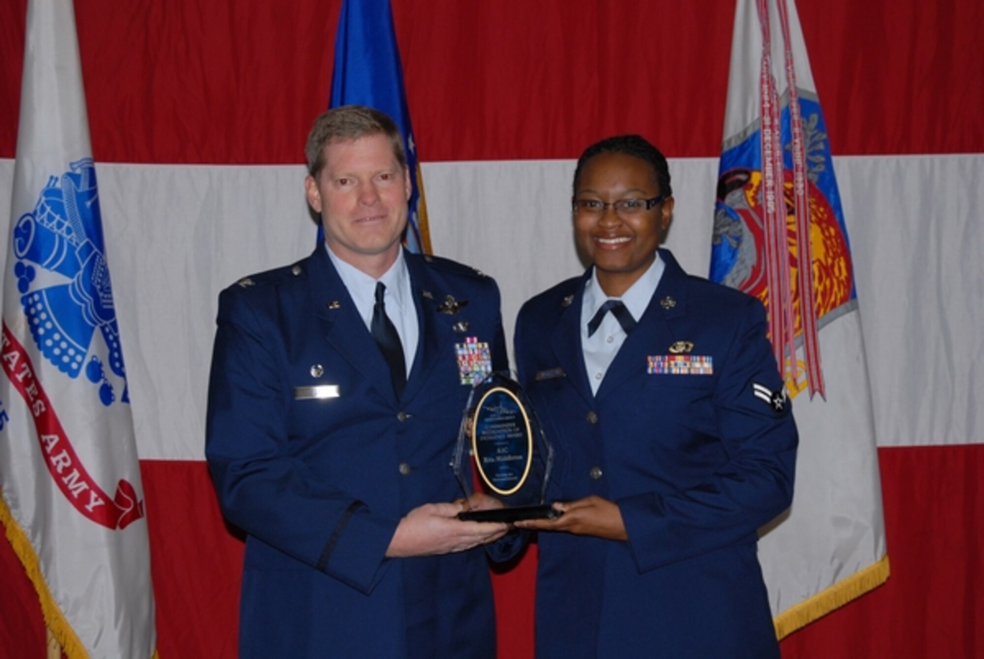 Airman 1st Class Rita Middleton of the 192nd Airlift Squadron accepts her Commander’s Award for Excellence from squadron commander Col. Kyle Reid at the annual Nevada Air National Guard’s Awards Ceremony on December 8.  NV ANG photo by Senior Airman Ashif Halim.  Released.