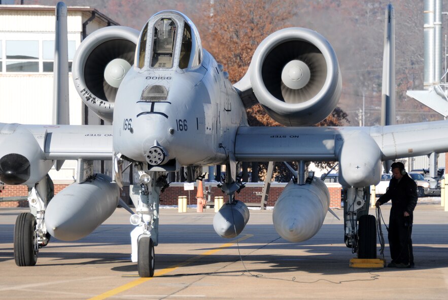 Tech. Sgt. Chris Cooper, a crew chief with the 188th Aircraft Maintenance Squadron, conducts preflight inspections on an A-10C Thunderbolt II (Tail No. 166).  The A-10 was one of two Warthogs from the 188th Fighter Wing's Ebbing Air National Guard Base in Fort Smith, Ark., delivered to Moody Air Force Base, Ga., Dec. 12, 2013, as part of the 188th’s on-going conversion from a fighter mission to remotely piloted aircraft and Intelligence mission, which will include a space-focused targeting squadron. (U.S. Air National Guard photo by Tech Sgt. Josh Lewis/188th Fighter Wing Public Affairs)