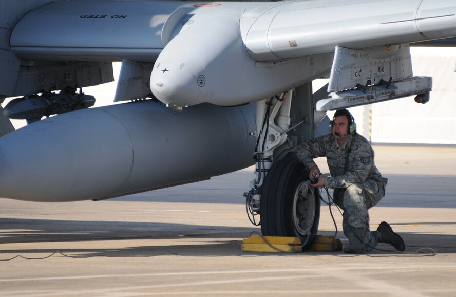 Tech. Sgt. Eric Jones, a crew chief with the 188th Aircraft Maintenance Squadron, communicates with the pilot before his A-10C Thunderbolt II "Warthog" departs for Moody Air Force Base, Ga., Dec. 12, 2013. Tail Nos. 0630 and 0166 departed the 188th Fighter Wing's Ebbing Air National Guard Base as part of the wing’s on-going conversion from a fighter mission to remotely piloted aircraft and Intelligence mission, which will include a space-focused targeting squadron. (U.S. Air National Guard photo by Tech Sgt. Josh Lewis/188th Fighter Wing Public Affairs)