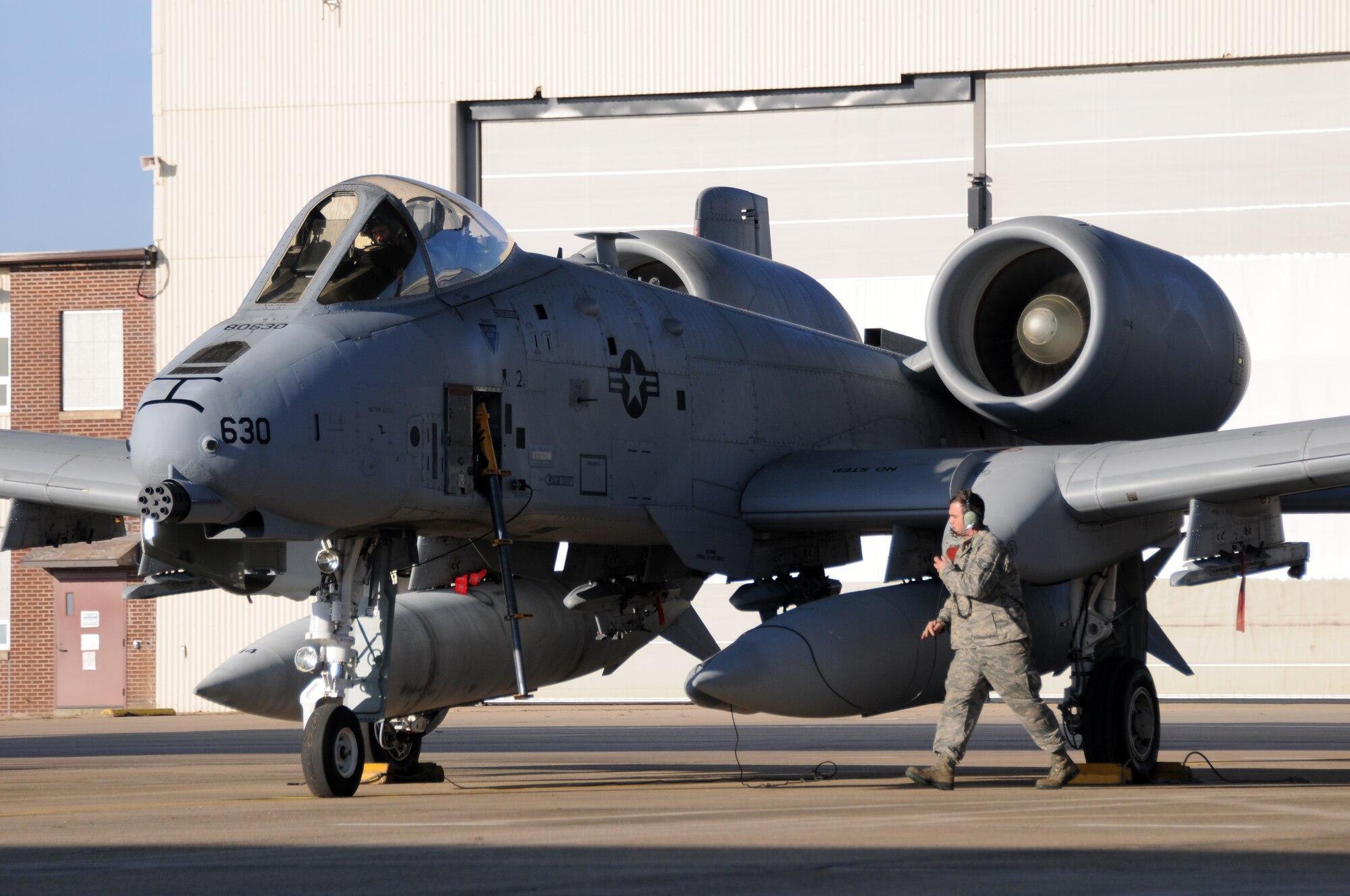 Tech. Sgt. Eric Jones, a crew chief with the 188th Aircraft Maintenance Squadron, communicates with Capt. Michael McVay of the 74th Fighter Squadron, Moody Air Force Base, Ga. McVay is delivering one of two A-10C Thunderbolt IIs from the 188th Fighter Wing's Ebbing Air National Guard Base to Moody AFB as part of the wing’s on-going conversion from a fighter mission to remotely piloted aircraft and Intelligence mission, which will include a space-focused targeting squadron. (U.S. Air National Guard photo by Tech Sgt. Josh Lewis/188th Fighter Wing Public Affairs)
