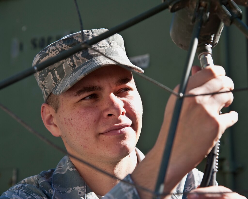 Senior Airman Brandon Seyl, 1st Special Operations Communications Squadron radio frequency transmissions systems journeyman, connects a cable to an antenna at Hurlburt Field, Fla., Dec. 12, 2013. With antennas, it’s challenging to ensure sufficient line-of-sight is established with satellites if there’s mountainous terrain, according to Seyl. (U.S. Air Force photo/Senior Airman Michelle Vickers)  