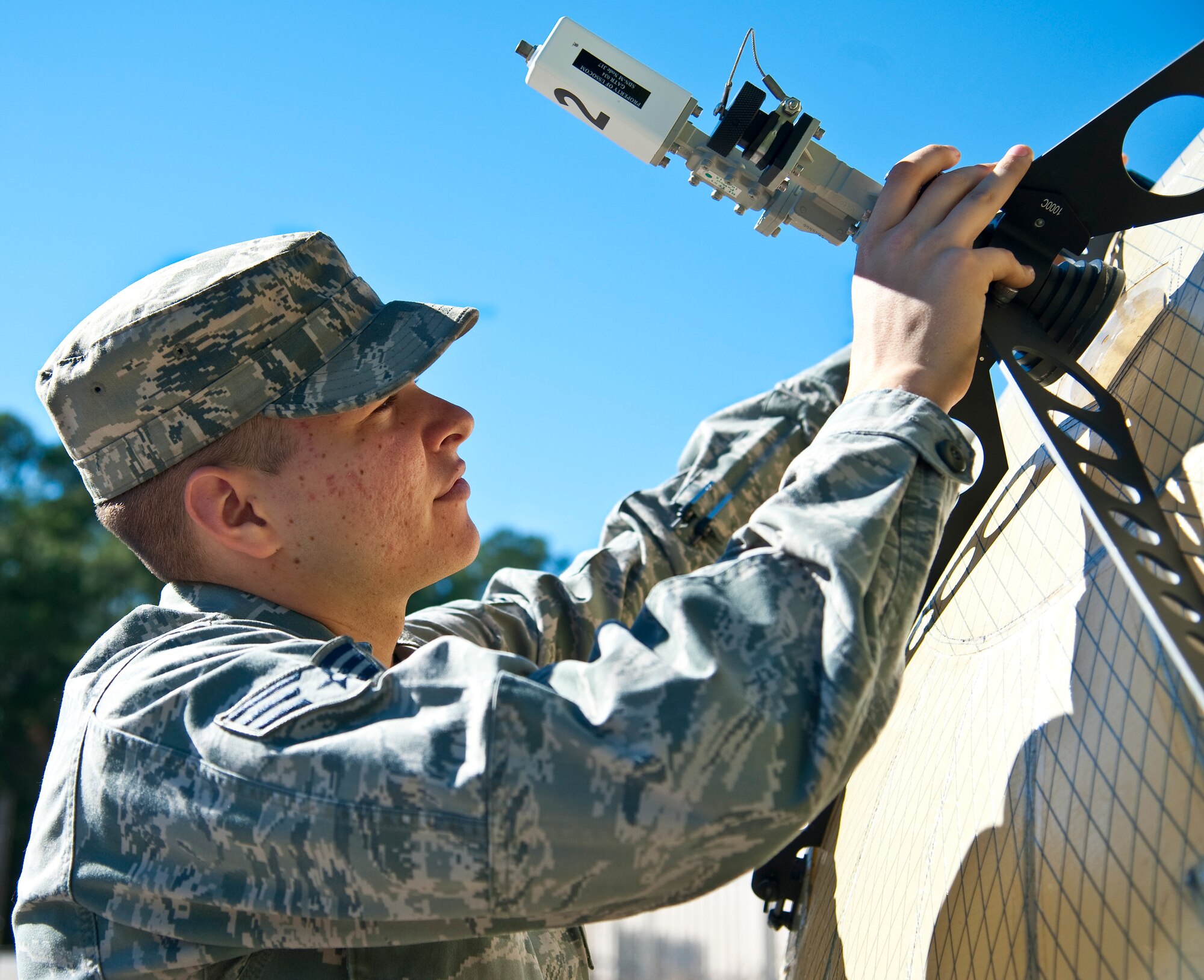 Senior Airman Brandon Seyl, 1st Special Operations Communications Squadron radio frequency transmissions systems journeyman, adjusts  satellite communication systems at Hurlburt Field, Fla., Dec. 12, 2013. The tactical communications flight creates channels so command and control can be conducted. (U.S. Air Force photo/Senior Airman Michelle Vickers)  