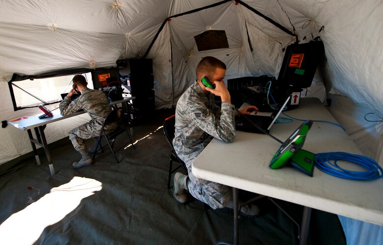 Senior Airmen Brandon Seyl, 1st Special Operations Communications Squadron radio frequency transmissions systems journeyman, and Derek Giesbrecht, 1st SOCS cyber transport technician, check phone lines at Hurlburt Field, Fla., Dec. 12, 2013. The tactical communications flight contains everything necessary to establish communications at a remote location for up to 30 days. (U.S. Air Force photo/Senior Airman Michelle Vickers)