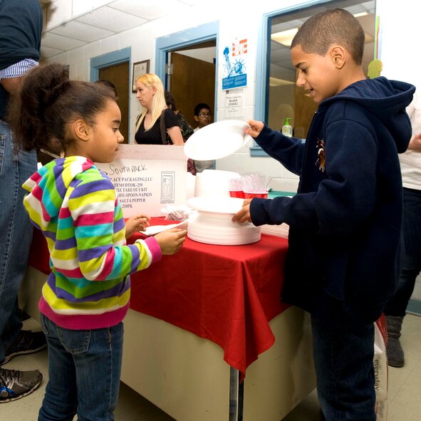 Members of the 7th Force Support Squadron serve food during the 24th annual South Park holiday dinner Dec. 13, 2013, in Abilene, Texas. The dinner was a traditional holiday meal that was comprised of ham, turkey, corn, green beans, stuffing and yams. (U.S. Air Force photo by Airman 1st Class Autumn Velez/Released)