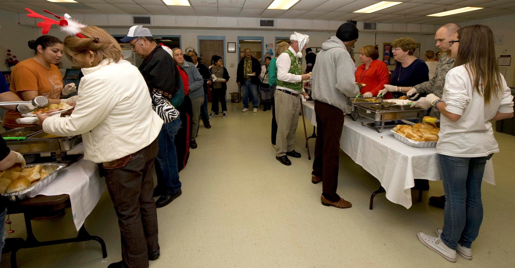 Members of the 7th Force Support Squadron serve food during the 24th annual South Park holiday dinner Dec. 13, 2013, in Abilene, Texas. The dinner was a traditional holiday meal that was comprised of ham, turkey, corn, green beans, stuffing and yams. (U.S. Air Force photo by Airman 1st Class Autumn Velez/Released)