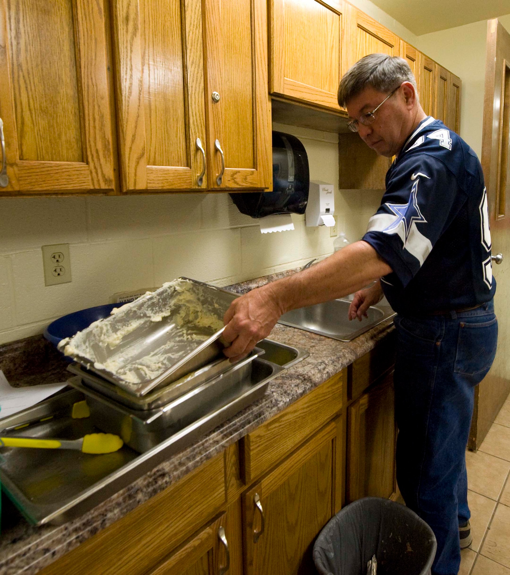 Jim Goodwin, 7th Force Support Squadron, washes dishes during the 24th annual South Park holiday dinner event Dec. 13, 2013 in Abilene, Texas. The event was made possible from donations made by local businesses. About 30 volunteers served over 125 meals to the local community. (U.S. Air Force photo by Airman 1st Class Autumn Velez/Released)