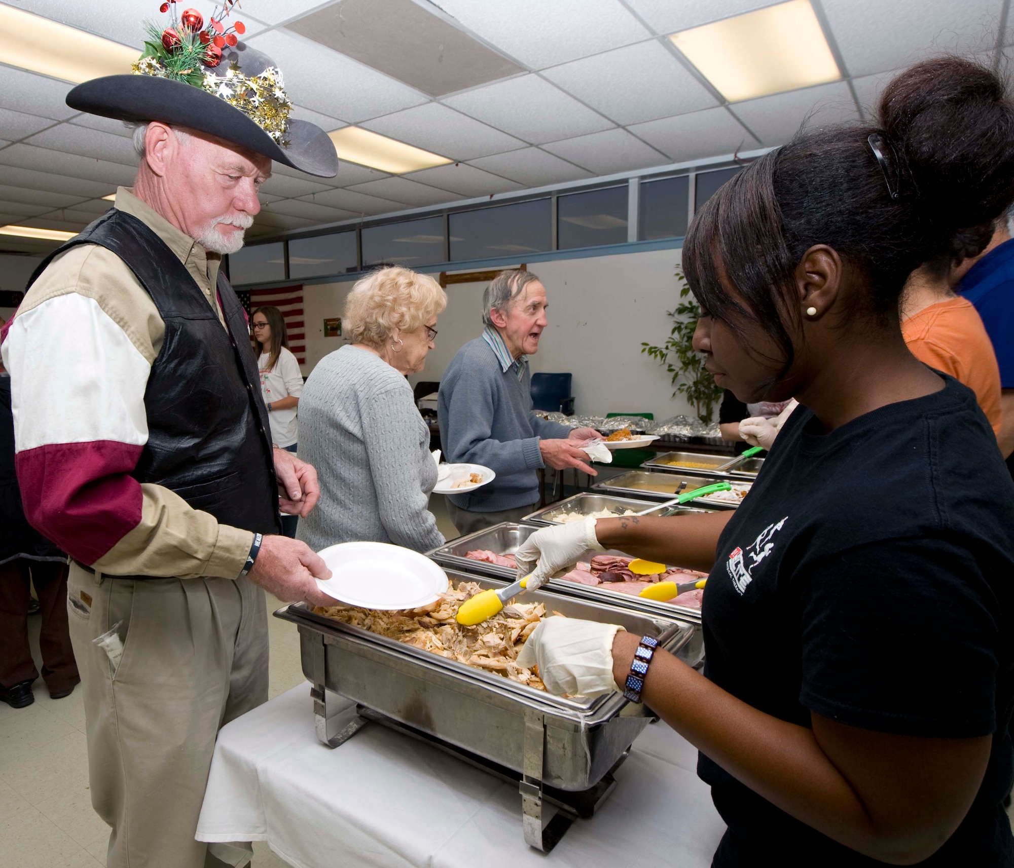 U.S. Air Force Senior Airman Rachel Devane, 7th Force Support Squadron, serves turkey to a patron of the annual South Park holiday dinner Dec. 13, 2013, in Abilene, Texas. The dinner is an annual charity event in which the squadron prepares and serves meals to members of the local Abilene community. This year marks the 24th year. (U.S. Air Force photo by Airman 1st Class Autumn Velez/Released)