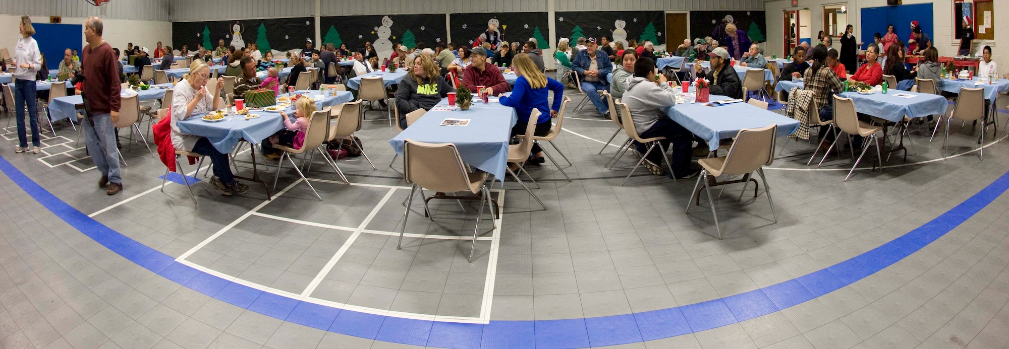 Airmen from the 7th Force Support Squadron served meals to the Abilene community Dec. 13, 2013, in Abilene, Texas. This year the squadron was able to feed around 125 people during the 24th annual South Park holiday dinner. The event is a charity dinner that takes place each year at the South Park Recreation Center. (U.S. Air Force photo by Airman 1st Class Autumn Velez/Released)