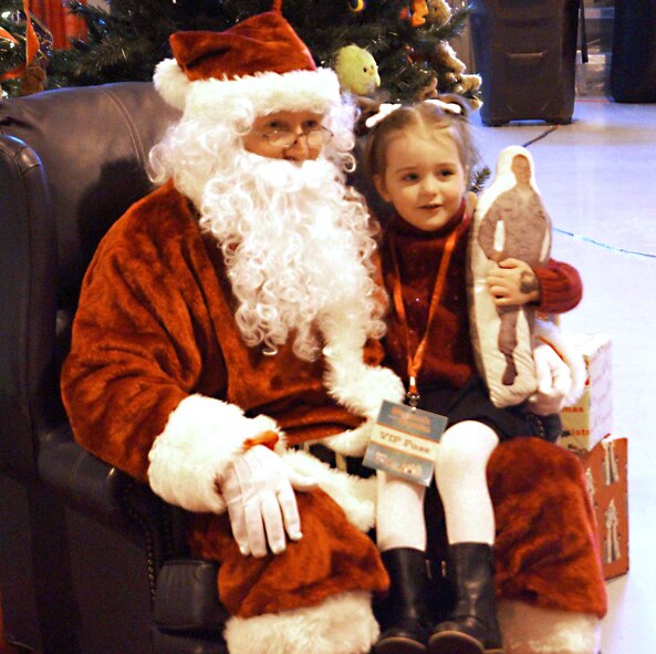 Lila Trickey, daughter of Master Sgt. Jason Trickey, with the 71st Operations Support Squadron, poses for a photo with Santa during the annual family event “Breakfast with Santa,” Dec. 14 in Hangar 170 at Vance Air Force Base, Okla.  (Courtesy photo)