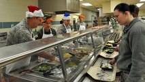 Members of the 916th Air Refueling Wing leadership team get into the holiday spirit by serving lunch at the Southern Eagle dining facility during the December drill weekend. (U.S. Air Force photo by Staff Sgt. Alan Abernethy, 916th ARW/PA)  
 
