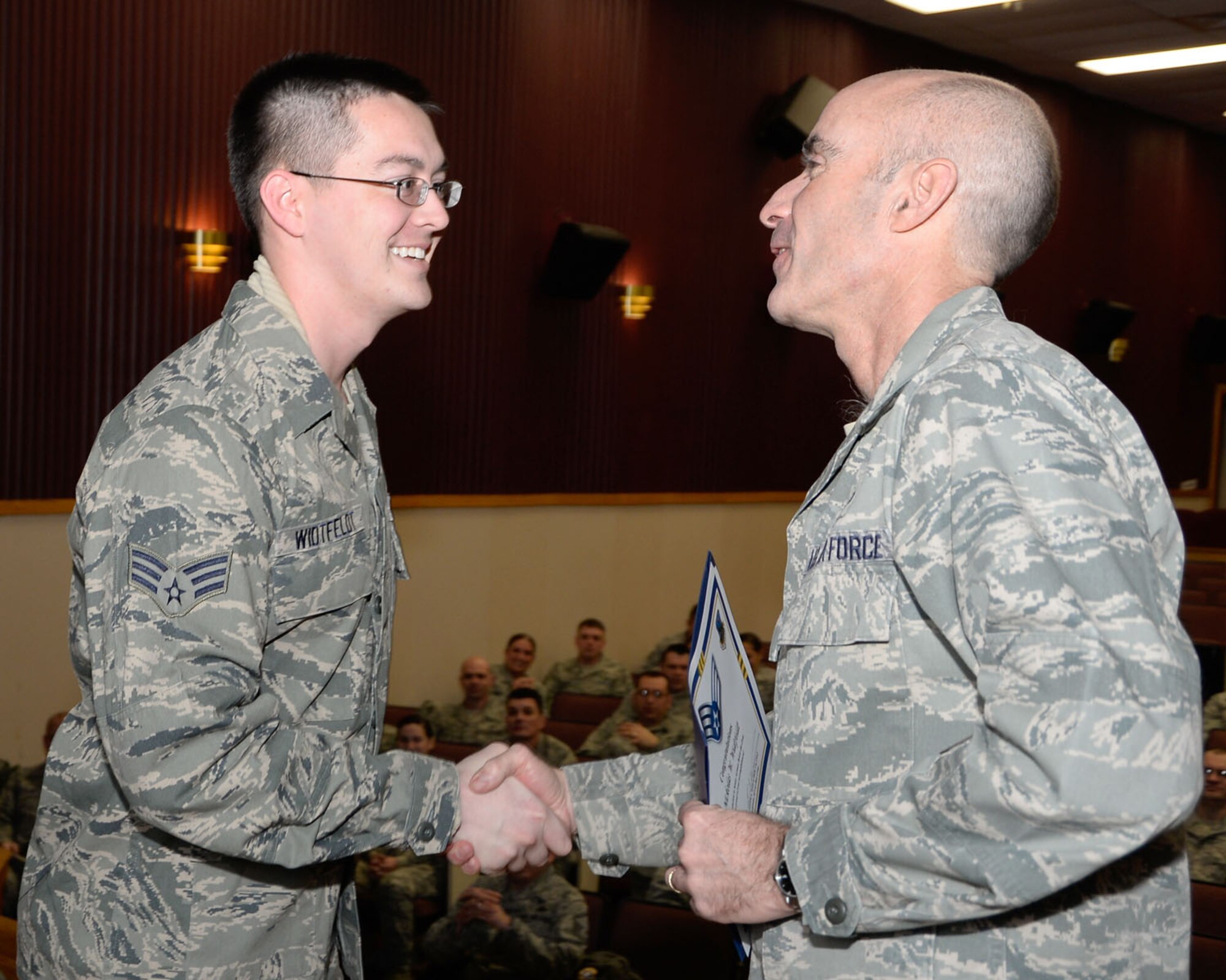 66th Air Base Group Commander Lester A. Weilacher congratulates Airman 1st Class Nickolas Widtfeldt on receiving senior airman below-the-zone Dec 19. Below-the-zone is an opportunity for exceptionally well-qualified airman 1st class a consideration for promotion to senior airman that is six months earlier than usual. (U.S. Air Force photo by Mark Herlihy)