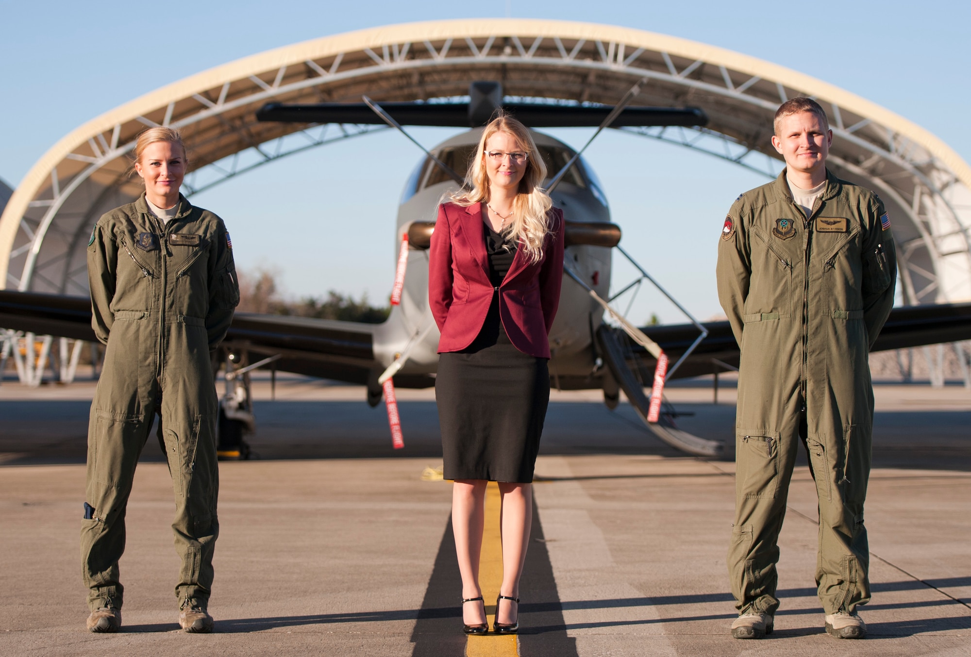 Senior Airman Rebecca Stinson, 711th Special Operations Squadron loadmaster, Jordan Roby, 1st Special Operations Contracting Squadron contract specialist, and Capt. Joshua Stinson, 34th Special Operations Squadron U-28A instructor pilot, pose for a photo at Hurlburt Field, Fla., Dec. 18, 2013. The three family members serve within Air Force Special Operations Command as respective enlisted, civilian and commissioned Air Commandos. (U.S. Air Force photo/Senior Airman Krystal Garrett)