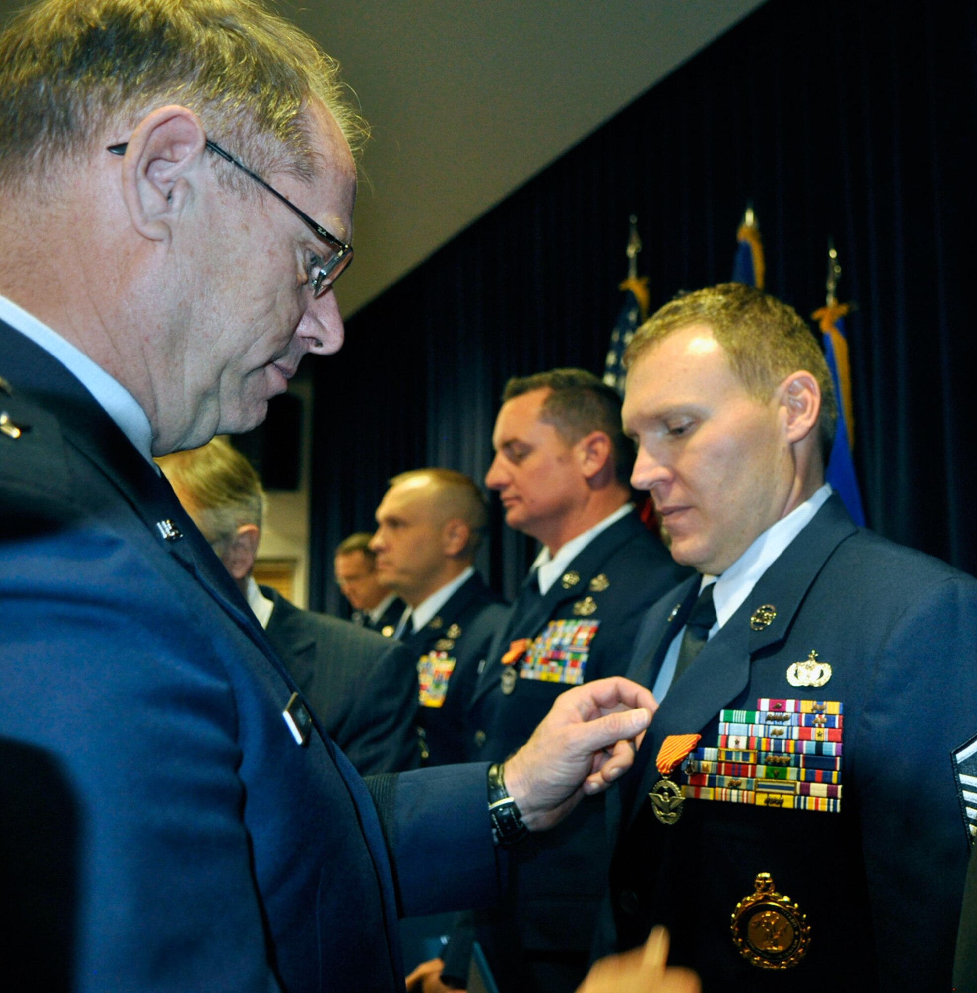 Master Sgt. Clinton Dudley, right, receives the Air Force Combat Action Medal from Nevada Adjutant General Brig. Gen. William Burks on Dec. 5. (Photo by Senior Airman Ashif Halim, 152nd Airlift Wing Public Affairs/Released)