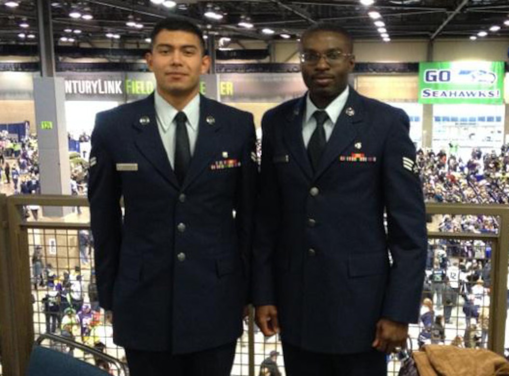 Senior Airman Adedapo “Odie” Odupitan (right), a medical technician with the 446th Aerospace Medicine Squadron, and Airman 1st Class Roberto Taddeo, medical technician with the 446th Aeromedical Staging Squadron (left), volunteered to present the U.S. flag during the Seattle Seahawks’ Salute to Service game, Nov. 17 at Century Link Field in Seattle, Wash.  Reservists from the 446th Airlift Wing participated in both pregame and halftime ceremonies at the military appreciation game.  (U.S. Air Force photo by 1st Lt. Lori Fiorello)