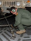 Staff Sgt. Christopher Brink, a loadmaster from the 535th Airlift Squadron, secures a HUMVEE on a C-17 Globemaster III during a validation exercise at Wheeler Army Airfield, Hawaii, Dec. 16, 2013. During the VALEX, Brink and fellow loadmaster, Senior Airman Kacee Kemper, advised and demonstrated the proper way to secure equipment inside the aircraft. (U.S. Air Force photo/Staff Sgt. Terri Paden)