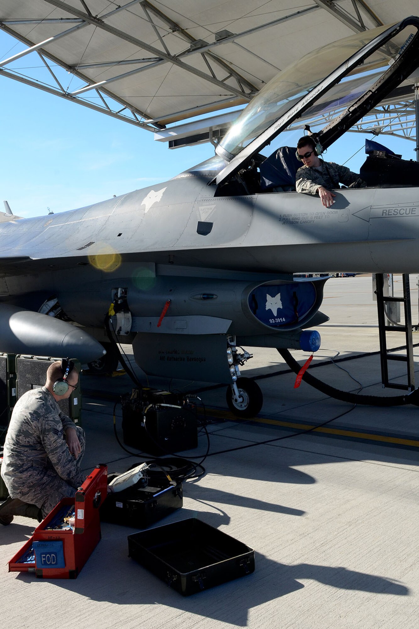 U.S. Air Force Senior Airmen Robert Tucker (left) and Earl Sale, with the 495th Fighter Group, Det. 157, 169th Aircraft Maintenance Squadron avionics shop at McEntire Joint National Guard Base, South Carolina Air National Guard, set up the Joint Service Electronic Combat Systems Tester to an F-16 Fighting Falcon, Dec. 11, 2013. The JSECST is a 180-day preventative maintenance practice that performs a confidence test of the radar threat warning system in the jet.  (U.S. Air National Guard photo by Tech. Sgt. Caycee Watson/Released)