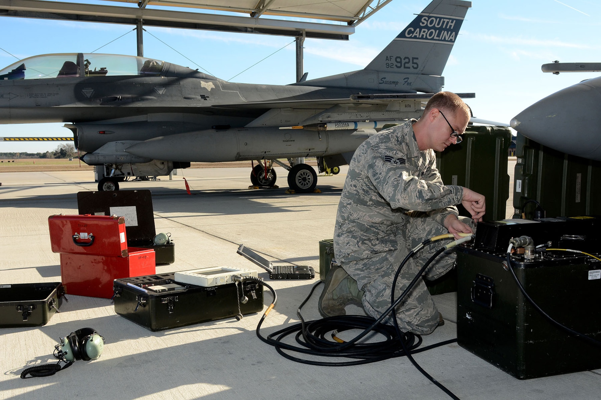 U.S. Air Force Senior Airman Robert Tucker, with the 495th Fighter Group, Det. 157, 169th Aircraft Maintenance Squadron avionics shop at McEntire Joint National Guard Base, South Carolina Air National Guard, sets up the Joint Service Electronic Combat Systems Tester to an F-16 Fighting Falcon, Dec. 11, 2013. The JSECST is a 180-day preventative maintenance practice that performs a confidence test of the radar threat warning system in the jet.  (U.S. Air National Guard photo by Tech. Sgt. Caycee Watson/Released)