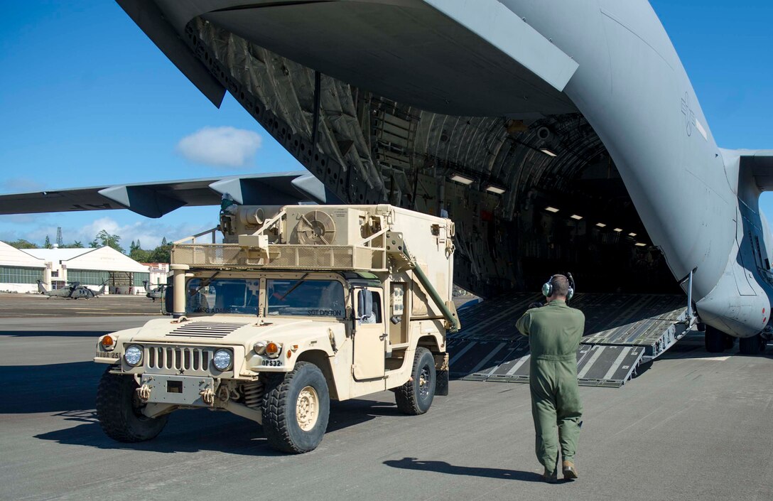 Soldiers from the 25th Infantry Division load a C-17 Globemaster III from the 535th Airlift Squadron during a validation exercise at Wheeler Army Airfield, Hawaii, Dec. 16, 2013. During the VALEX, a Hickam-based C-17 picked up two HUMVEES and 35 passengers to test the unit’s ability to rapidly deploy to anywhere within the Pacific area of responsibility within 24 hours. (U.S. Air Force photo/Staff Sgt. Terri Paden)