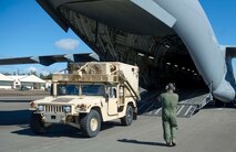 Soldiers from the 25th Infantry Division load a C-17 Globemaster III from the 535th Airlift Squadron during a validation exercise at Wheeler Army Airfield, Hawaii, Dec. 16, 2013. During the VALEX, a Hickam-based C-17 picked up two HUMVEES and 35 passengers to test the unit’s ability to rapidly deploy to anywhere within the Pacific area of responsibility within 24 hours. (U.S. Air Force photo/Staff Sgt. Terri Paden)