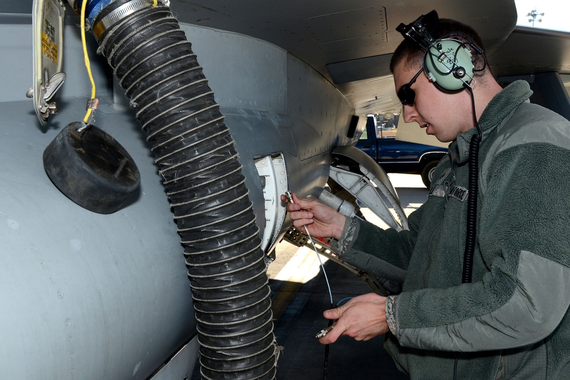 U.S. Air Force Senior Airman Earl Sale, with the 495th Fighter Group, Det. 157, 169th Aircraft Maintenance Squadron avionics shop at McEntire Joint National Guard Base, South Carolina Air National Guard, sets up the Joint Service Electronic Combat Systems Tester to an F-16 Fighting Falcon, Dec. 11, 2013. The JSECST is a 180-day preventative maintenance practice that performs a confidence test of the radar threat warning system in the jet.  (U.S. Air National Guard photo by Tech. Sgt. Caycee Watson/Released)