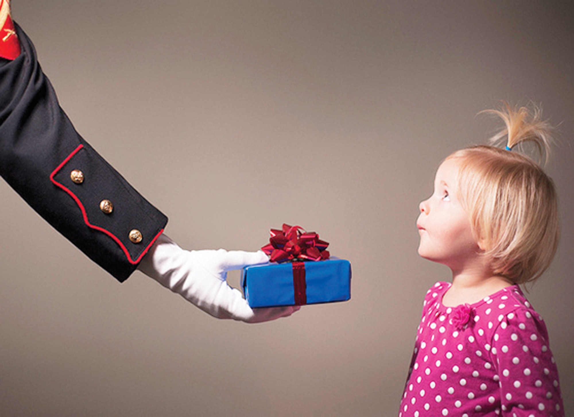 A little girl receives a gift from a Marine Reservist. (U.S. Marine Corps photo/Staff Sgt. Mark Fayloga)