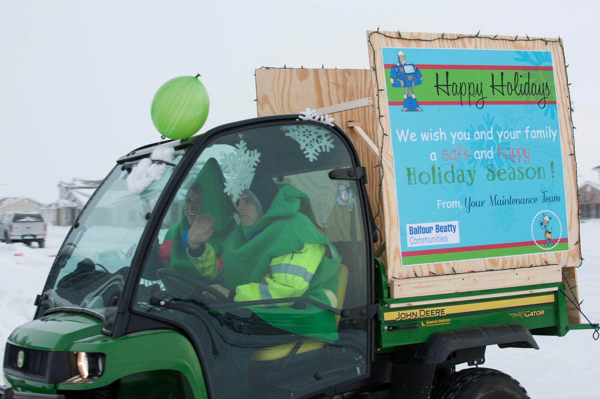 Members of Balfour Beatty Communities wave to onlookers during the holiday parade at Minot Air Force Base, N.D., Dec. 13. The parade was organized by BBC as a means to help the community usher in the holiday season. (U.S. Air Force photo/Senior Airman Stephanie Sauberan)