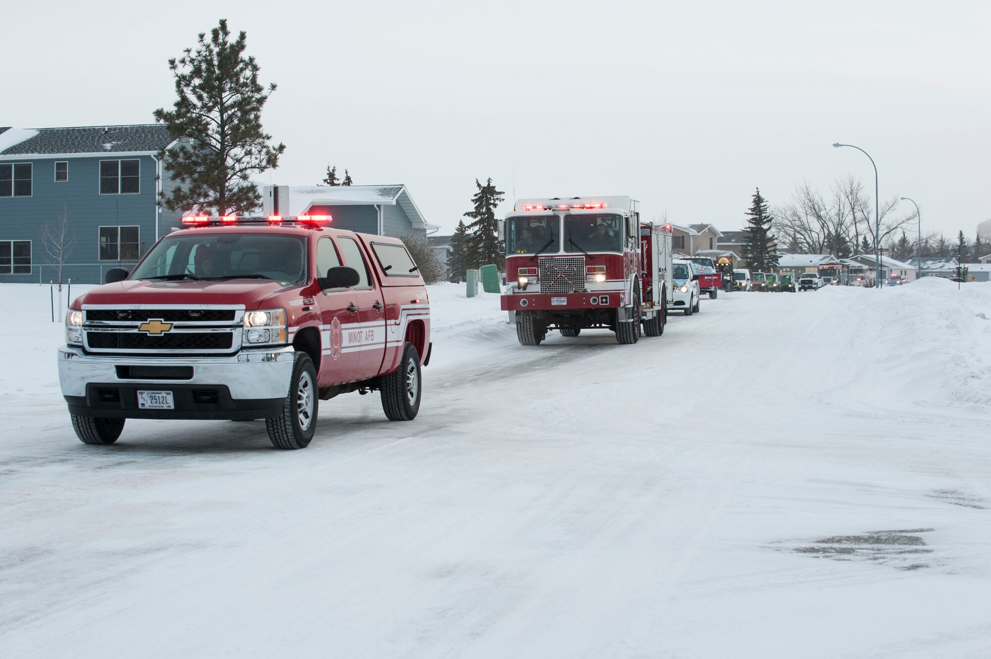 An assortment of vehicles and floats participate in the holiday parade at Minot Air Force Base, N.D., Dec. 13. The parade, which began at the base-exchange, wound through housing for nearly one hour playing Christmas music and passing out candy to waiting children. (U.S. Air Force photo/Senior Airman Stephanie Sauberan)