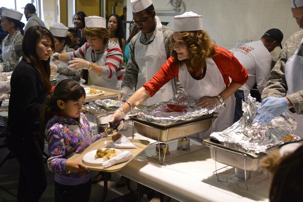 Food is served at Operation Holiday Cheer Dec. 18, one of Kirtland's biggest charitable events of the year. Hundreds of volunteers helped prepare and serve food at the event, which fed more than 1,000 from the local community. (Photo by Todd Berenger)
