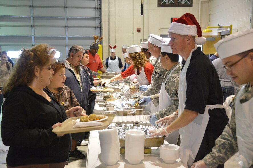 Food is served at Operation Holiday Cheer Dec. 18, one of Kirtland's biggest charitable events of the year. Hundreds of volunteers helped prepare and serve food at the event, which fed more than 1,000 from the local community. In addition, hundreds of new toys were delivered to children. The annual event is hosted by the Kirtland Fire Department. (Photo by Todd Berenger)
