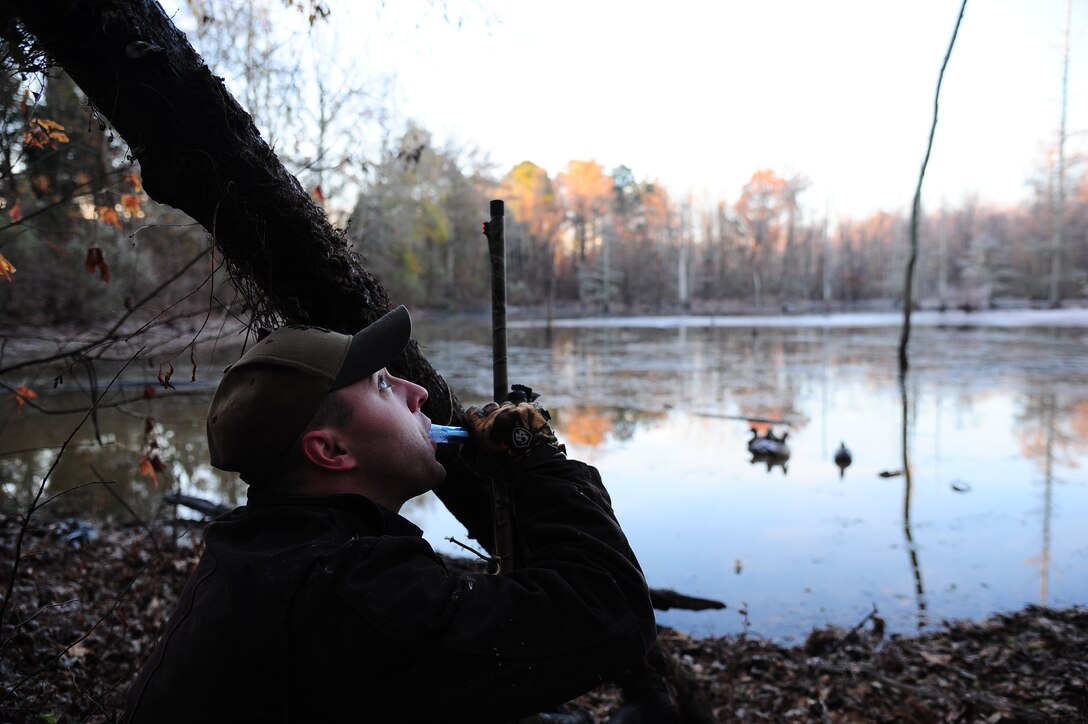 Staff Sgt. Cody Howk, 14th Operations Support Squadron and an avid hunter, looks up into the sky while he calls in a large group of ducks. Howk calls the ducks to bring them in to his decoys for a better shot.