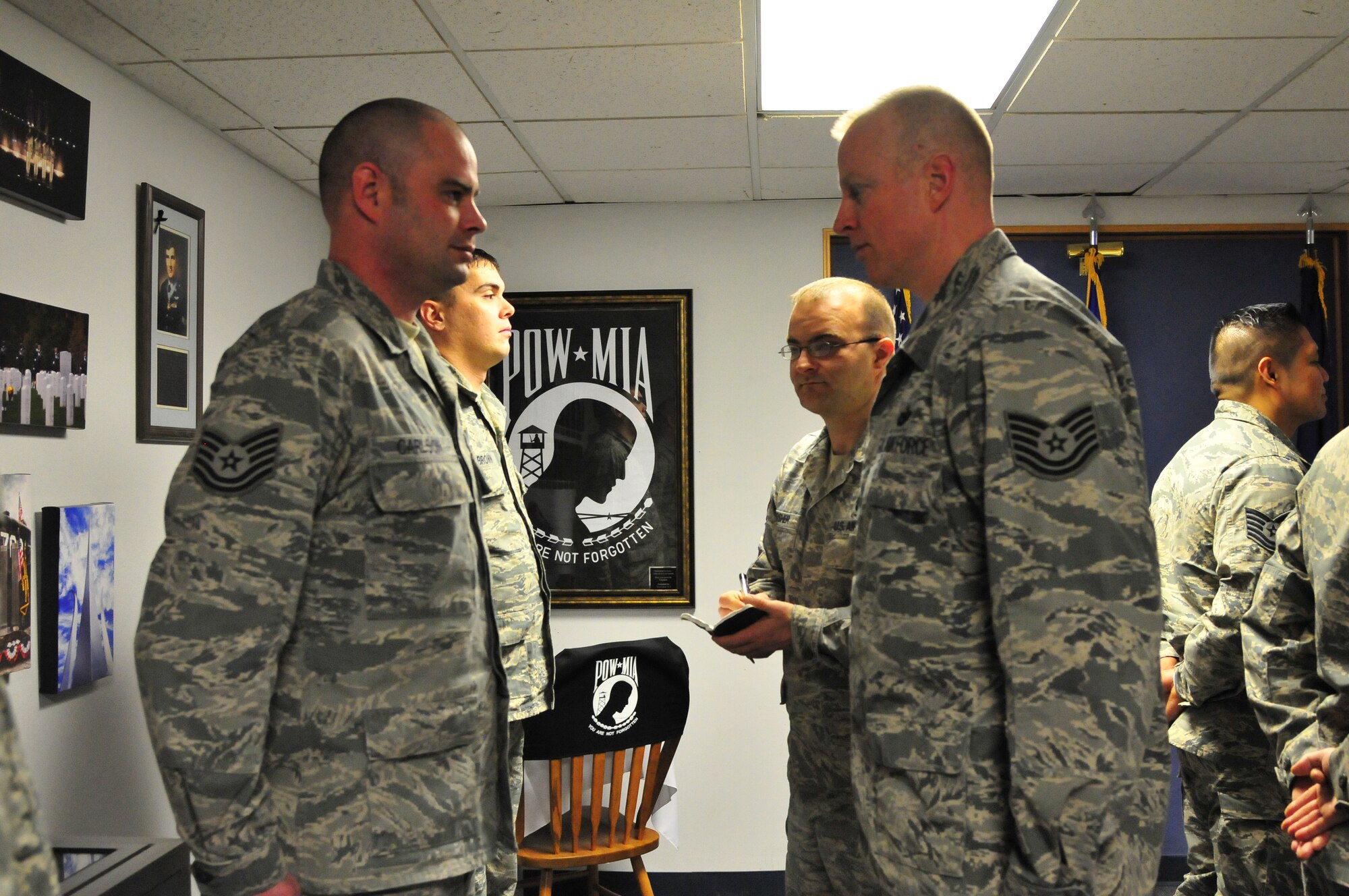 Tech. Sgt. Jarod Cappon, Elmendorf Professional Military Education Center instructor, evaluates Tech. Sgt Jared Carlson’s uniform during NCO Academy Class 14-1 Dec. 10, 2013, Eielson Air Force Base, Alaska. Cappon is deployed to Eielson from Joint Base Elmendorf-Richardson, Alaska to teach the in-resident PME course as a cost saving initiative for the Air Force. (U.S. Air Force photo by Master Sgt. Jason Vaught/Released)
