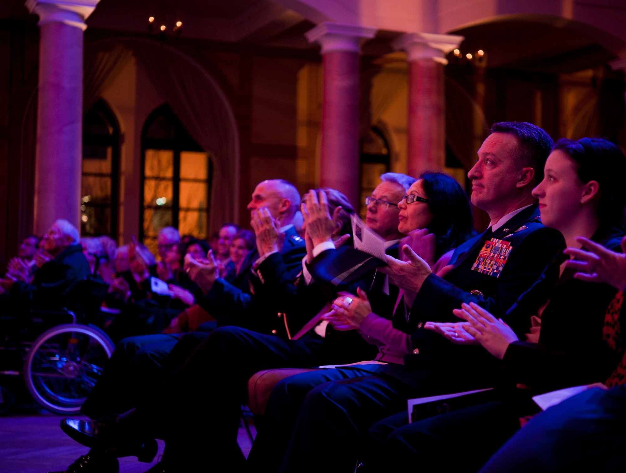 Concert attendees applaud the USAFE Band and Rheinland-Pfalz International Choir during the KMC Holiday Concert, Dec. 13, 2013. The annual concert has become tradition in the KMC area and in the local community. (U.S. Air Force photo/Senior Airman Damon Kasberg)