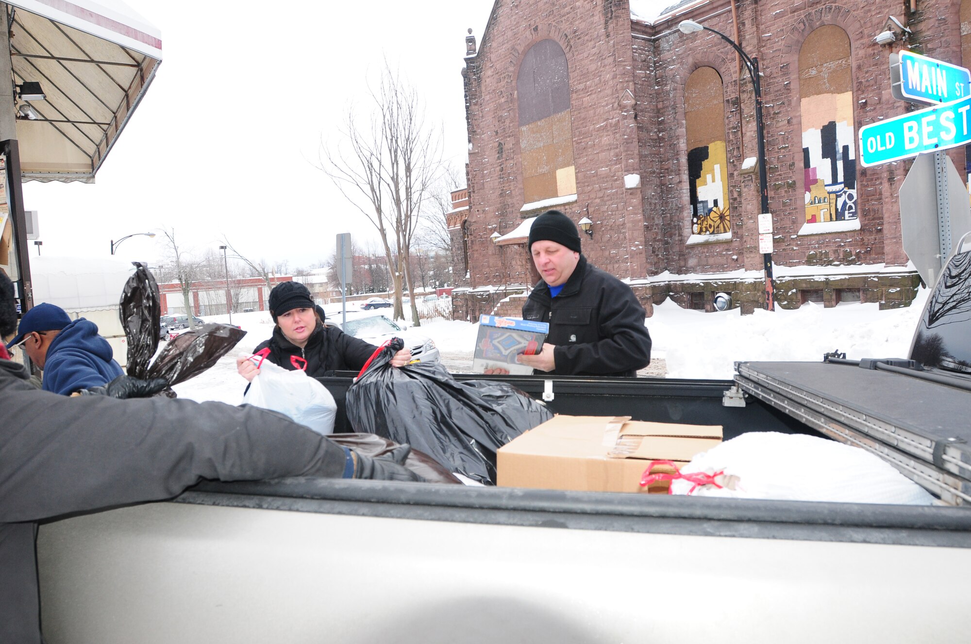Master Sgt. Melissa Shenefiel and Master Sgt. Kenneth Devole unload the donated clothing for the Western New York Veterans Housing Coalition in Buffalo, NY. on Dec. 18, 2013 (New York Air National Guard photo/Senior Master Sgt. Ray Lloyd)
