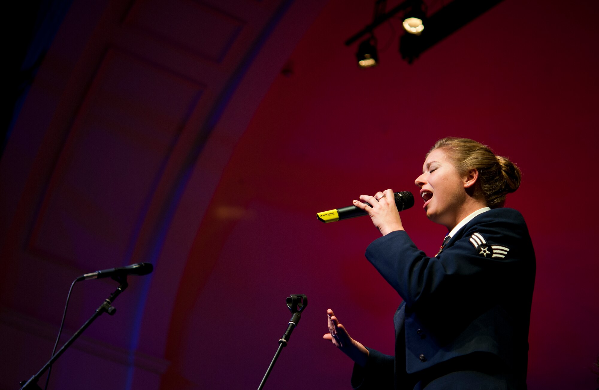 Senior Airman Carmen Emborski, USAFE Band vocalist, belts out holiday classics with her unique vocal style during the KMC Holiday Concert, Dec. 13, 2013. The band spends most of the season spreading joy through music and this annual concert is one of their most popular performances here. (U.S. Air Force photo/Senior Airman Damon Kasberg)