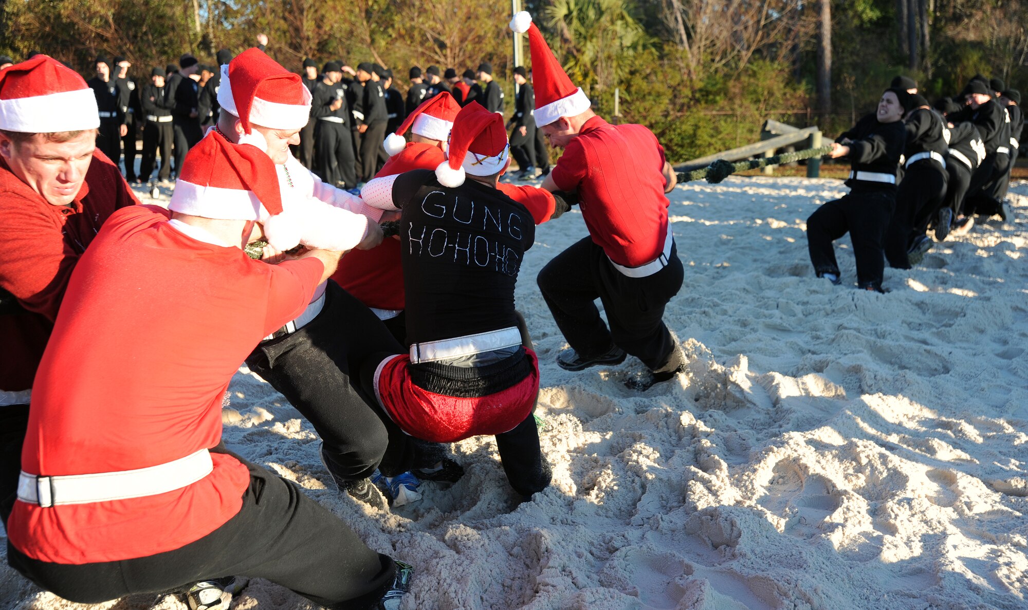 Tactical Air Control Party candidates compete during a tug-of-war match during their annual holiday physical training session on Hurlburt Field, Fla., Dec. 18, 2013. Many Air Commandos dressed in holiday apparel for the occasion. (U.S. Air Force photo/Senior Airman Kentavist P. Brackin) 