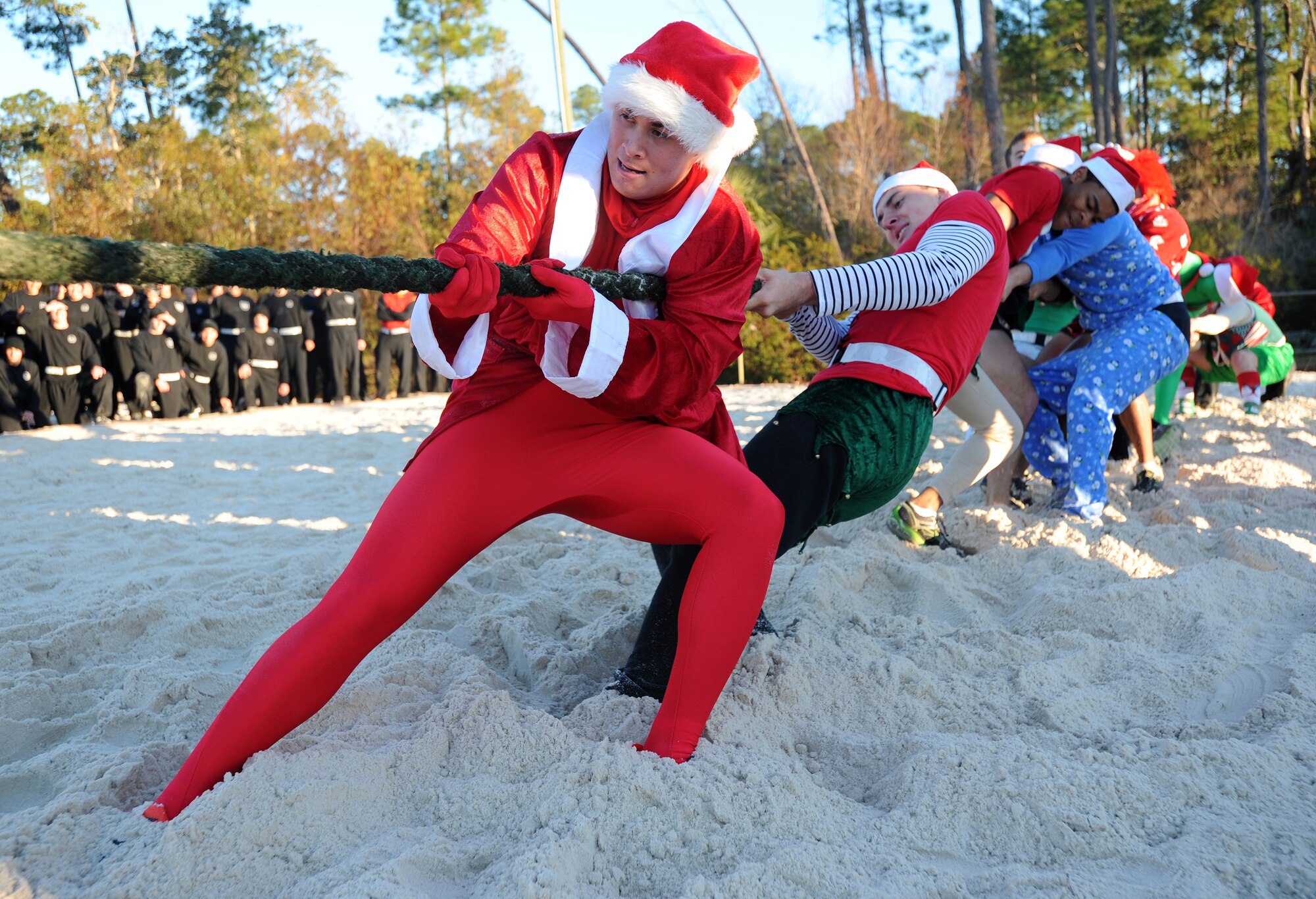 Tactical Air Control Party Air candidates brace themselves against their competition during a tug-of-war match on Hurlburt Field, Fla., Dec. 18, 2013. Airmen also participated in other events to include a humvee pull as part of their annual holiday physical training session. (U.S. Air Force photo/Senior Airman Kentavist P. Brackin) 