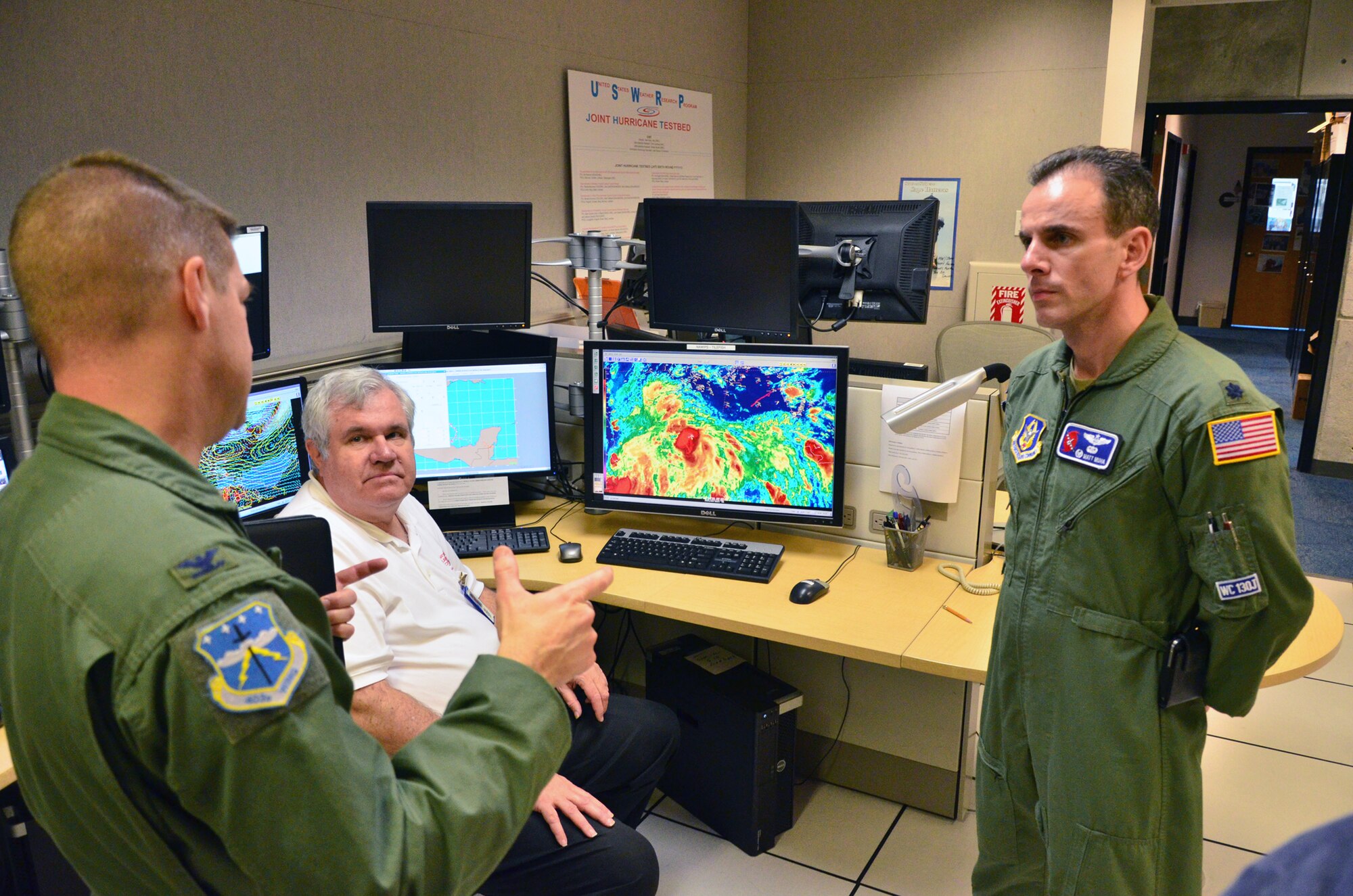 Col. Frank Amodeo, the 403rd Wing Commander (left) discusses the Hurricane
Hunting mission with Richard Pasch, the senior hurricane specialist at the
National Hurricane Center and Lt. Col. Matthew Muha, the new 53rd WRS
commander, (right) at the Center Dec 10.
