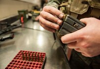 Senior Airman Zachery Butler, 791st Missile Security Forces Squadron response force leader, loads ammunition into a magazine for an M4 carbine before guard mount at Minot Air Force Base, N.D. Dec. 11. The 791st MSFS Airmen perform random inspections on issued ammunition to ensure that the rounds are serviceable and properly accounted for. (U.S. Air Force photo/Senior Airman Stephanie Sauberan)