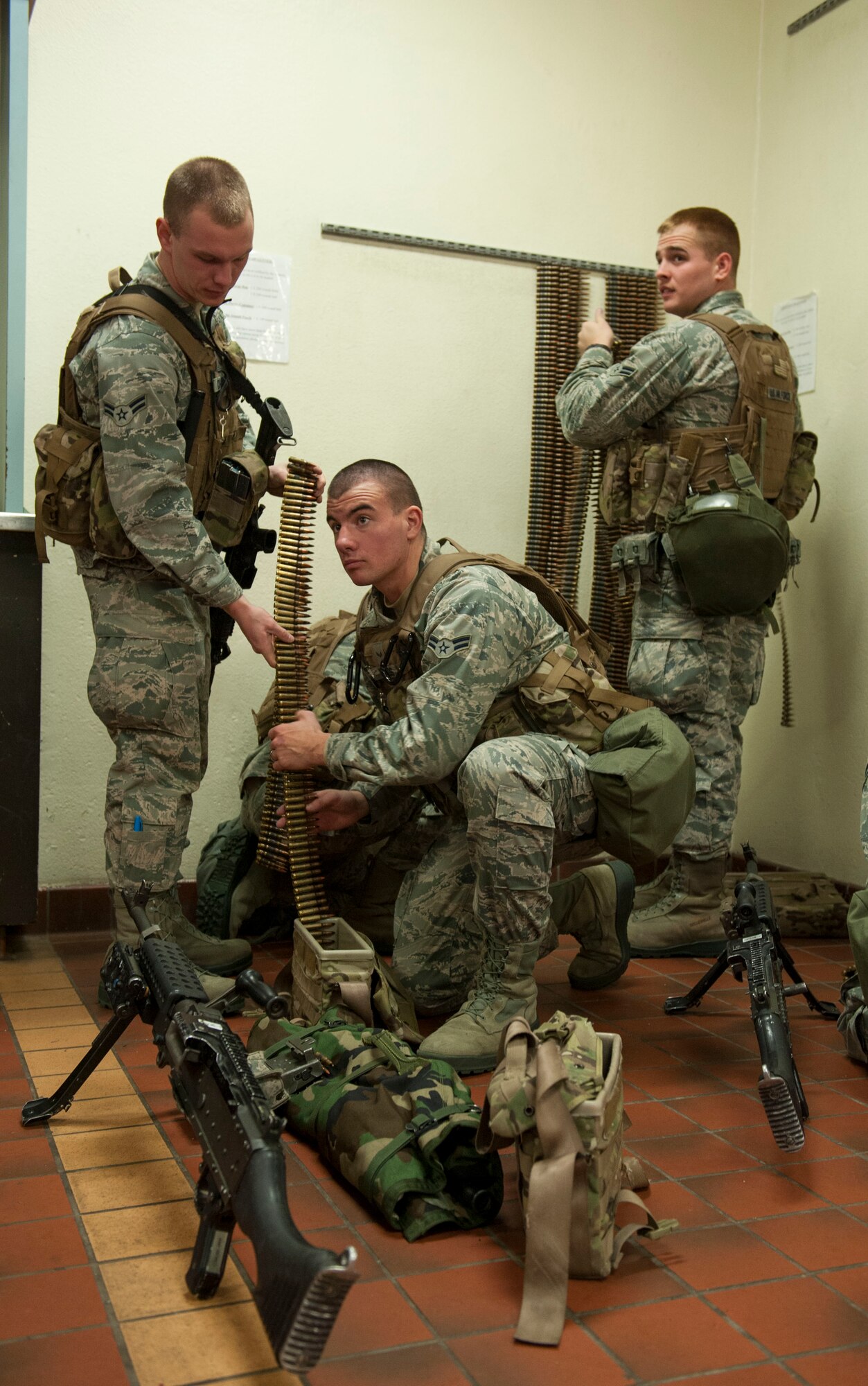 Airmen from the 791st Missile Security Forces Squadron pack ammunition for a M240B machine gun before guard mount at Minot Air Force Base, N.D. Dec. 11. The 791st MSFS Airmen employ a variety of weapons systems while deployed to the missile complex including the MK19 automatic grenade launcher, the M249 automatic rifle and the M203 grenade launcher to name a few. (U.S. Air Force photo/Senior Airman Stephanie Sauberan)