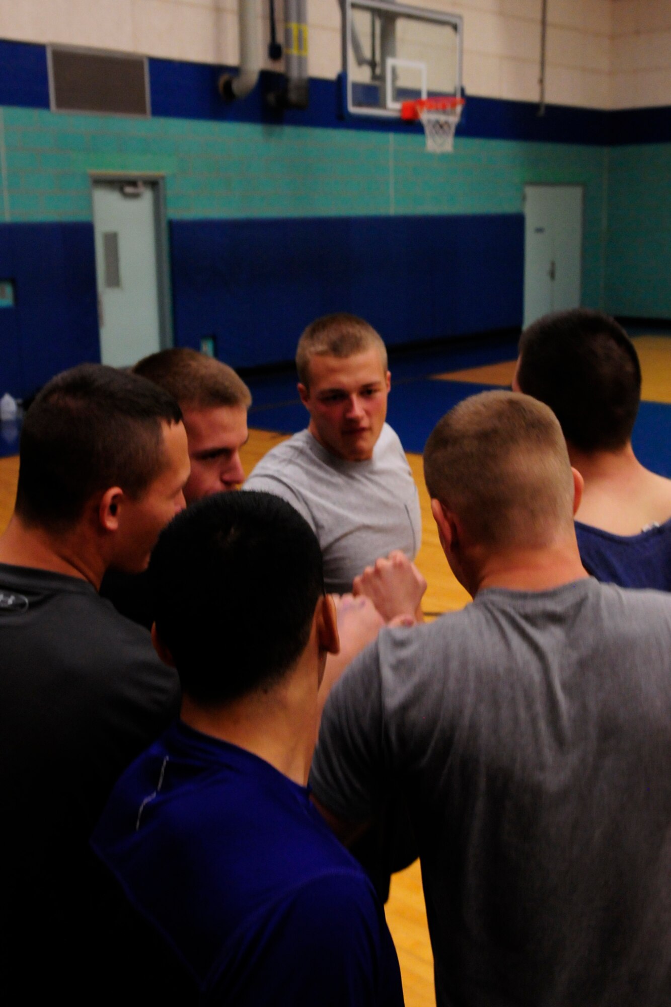 GOODFELLOW AIR FORCE BASE, Texas –312th Training Squadron students form a pre-game huddle at Mathis Fitness Center Dec. 14. During the huddle, students motivated each other for a game of dodge ball against U.S. Army 344th Military Intelligence Battalion students.(U.S. Air Force photo/ Airman 1st Class Devin Boyer)