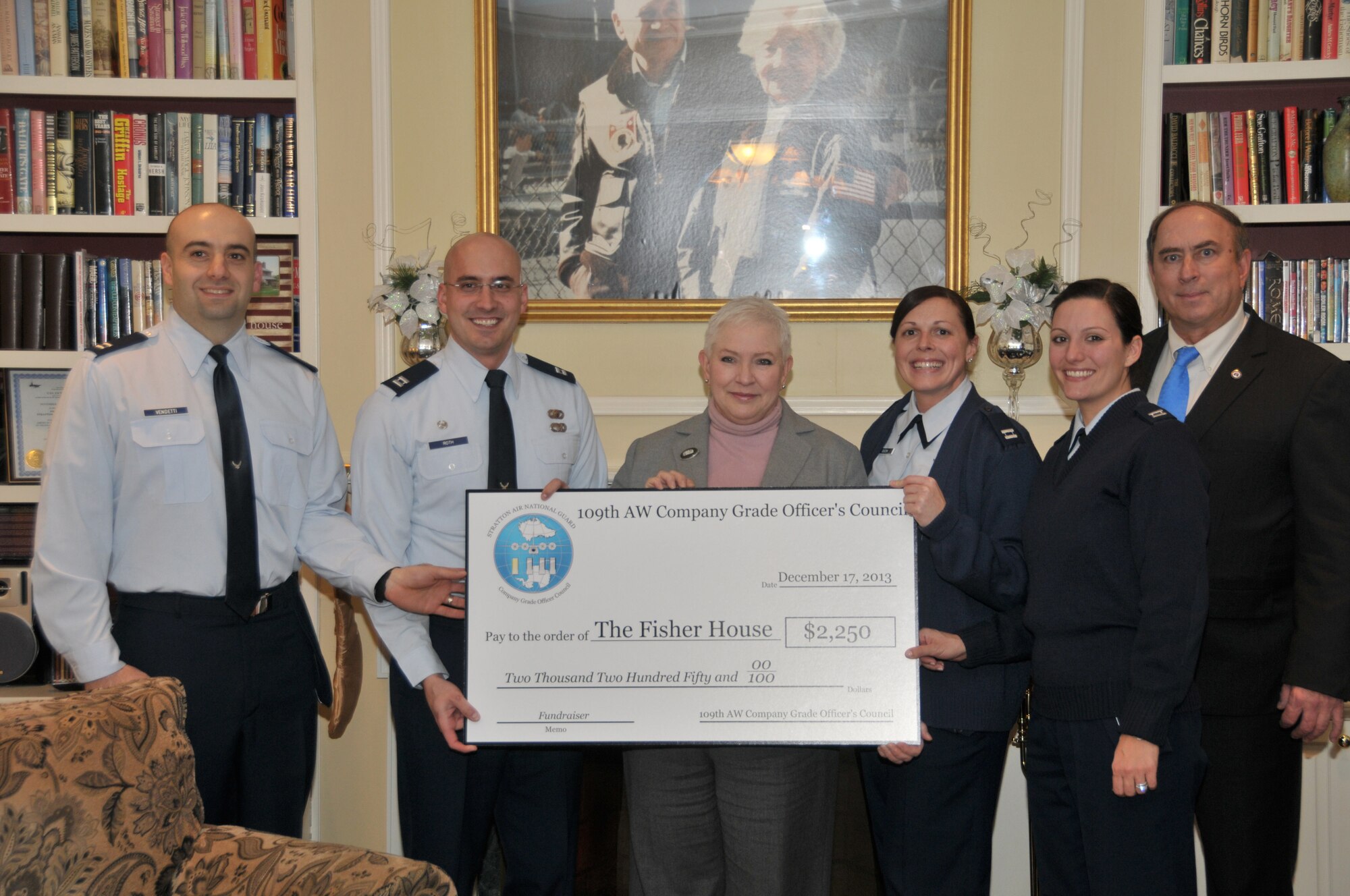 ALBANY, N.Y. -- The 109th Airlift Wing Company Grade Officer's Council donated $2,250 to the Fisher House on Dec. 17, 2013, with funds raised from a golf tournament the council hosted earlier in the year. Pictured are (from left) Capt. James Vendetti, Capt. James Roth, Linda Weiss, Stratton VA Medical Center Director, Capt. Melissa Cucchi, Capt. Ashley FitzGibbon and Jerry Jensen, Albany Fisher House Manager. (Air National Guard photo by Tech. Sgt. Catharine Schmidt/Released)