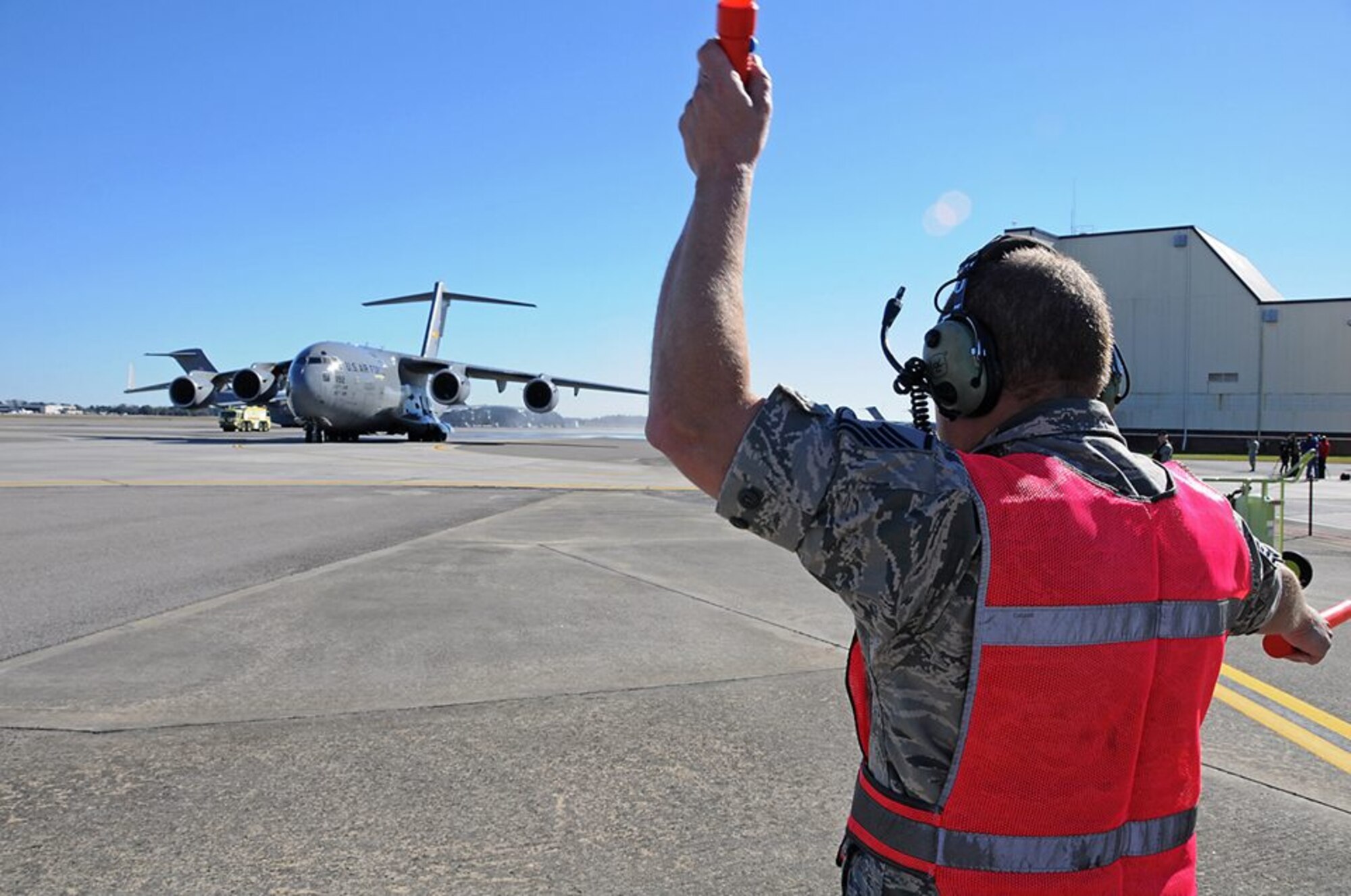 Master Sgt. Horace Bell, 315th Aircraft Maintenance Squadron, marshals "The Spirit of Charleston" after the jet passed the 20,000 flight hours mark this week.— at 315th Airlift Wing. (U.S. Air Force Reserve photo by Michael Dukes)
