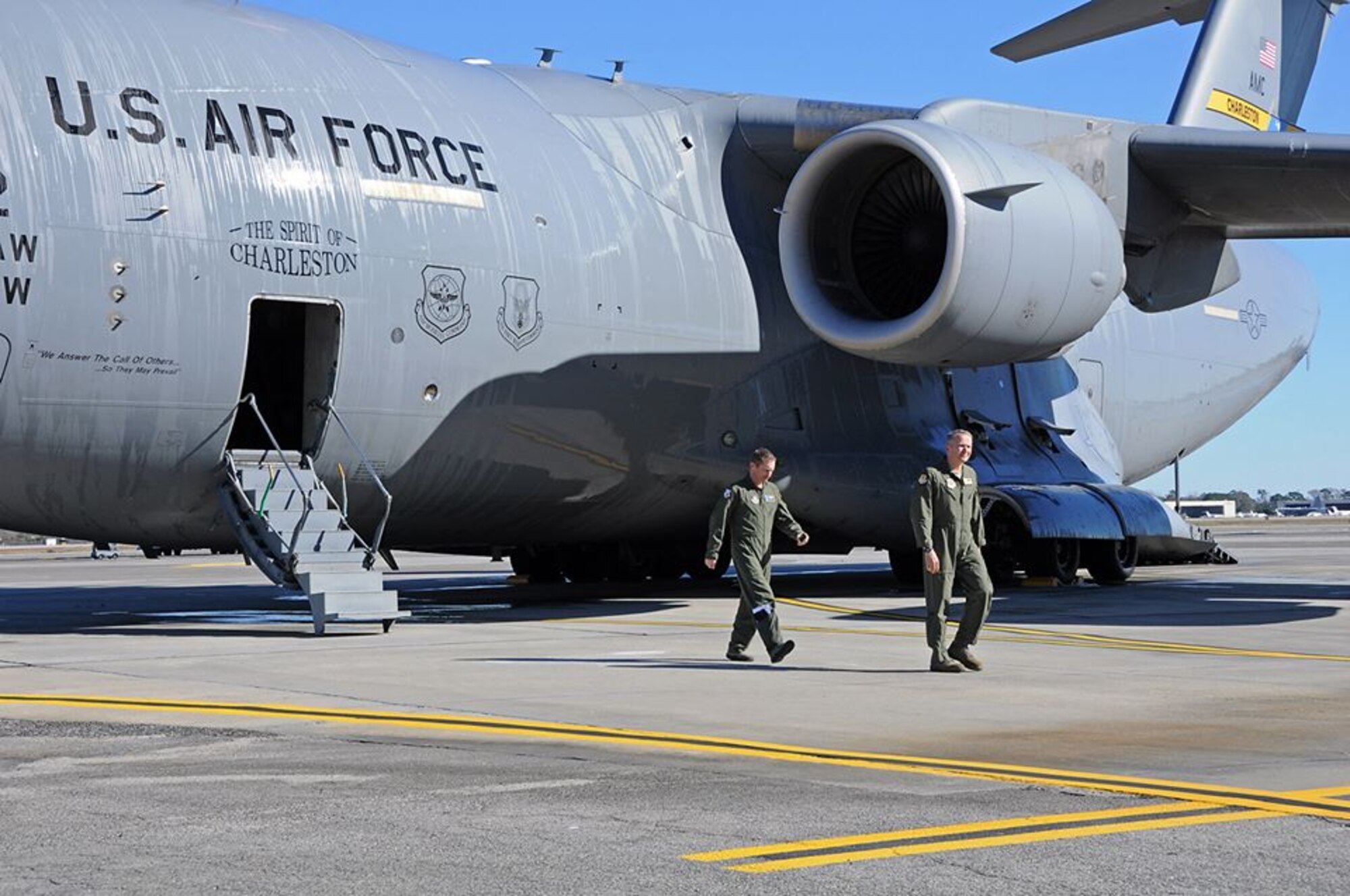 (Left) Col. James Fontanella, 315AW commander and Col. Darren Hartford, 437th AW commander exit "The Spirit of Charleston" after the jet passed the 20,000 flight hours mark this week.  (U.S. Air Force Reserve photo by Michael Dukes)