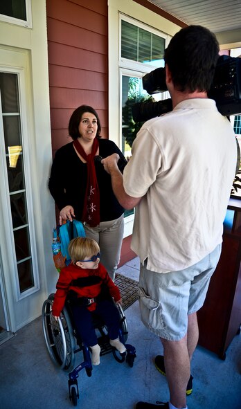 Natalie and Jack Lee are interviewed during MacDill Air Force Base’s Americans with Disabilities Act home unveiling, Dec. 18, 2013. The Lee family was one of the 10 families to be selected to live in the recently constructed ADA homes.  (U.S. Air Force photo by Staff Sgt. Brandon Shapiro/Released) 