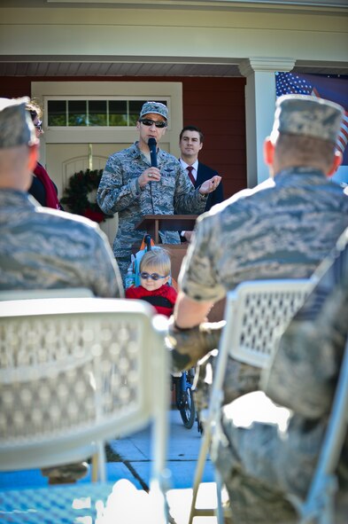 Col. Scott DeThomas, 6th Air Mobility Wing commander, addresses a crowd at MacDill Air Force Base’s Americans with Disabilities Act home unveiling, Dec. 18, 2013. The base recently completed a series of 10 new ADA home builds.  (U.S. Air Force photo by Staff Sgt. Brandon Shapiro/Released)