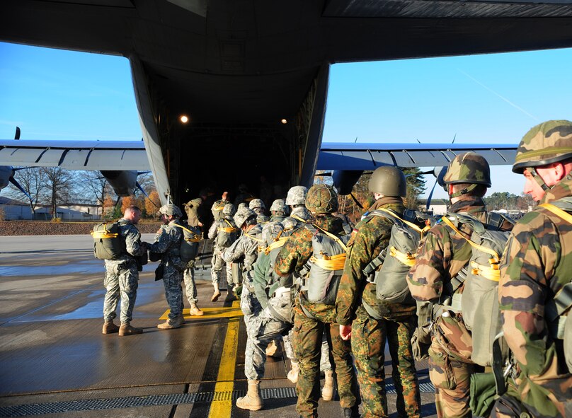 Paratroopers from several NATO countries board a C-130J Super Hercules for International Jump Week, Dec. 17, 2013, Ramstein Air Base, Germany. Jump Week is a chance for NATO countries and U.S. forces can build partnerships and train together. (U.S. Air Force photo/Senior Airman Hailey Haux)