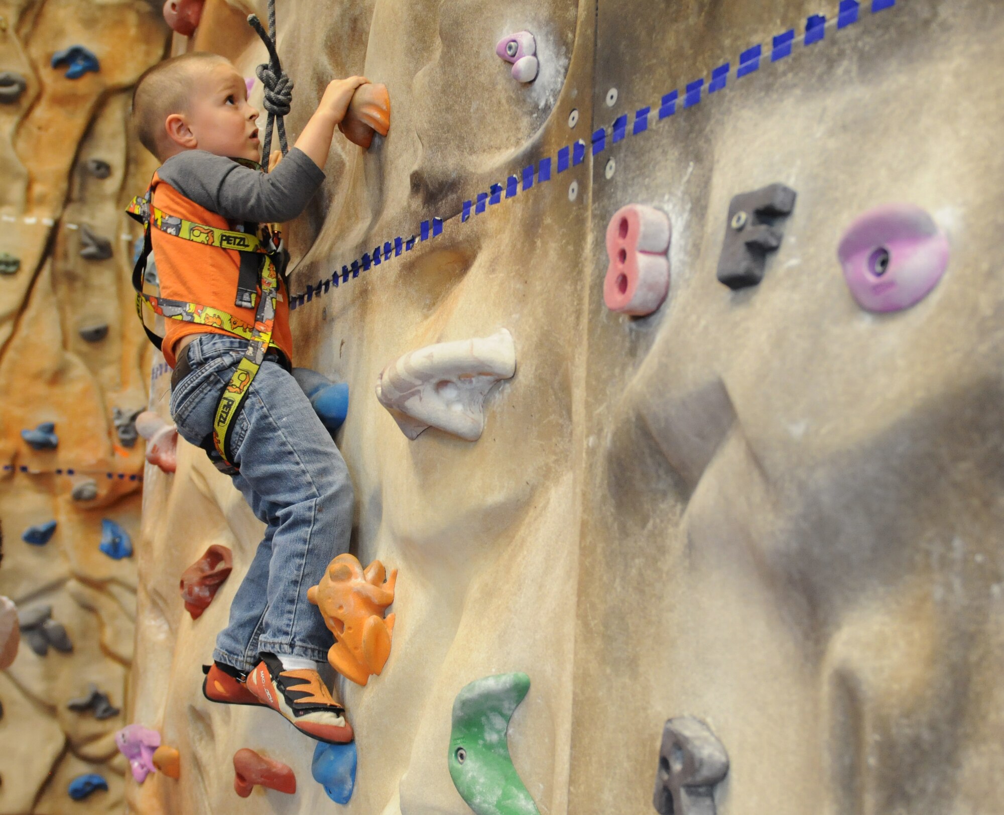 Isaac Siembida, son of Master Sgt. Jeremiah Siembida, U.S. Air Forces in Europe and Air Forces Africa command programs manager, climbs the rock wall at the Outdoor Recreation Center during an Exceptional Family Member Program event, May 2, 2013, Ramstein Air Base, Germany. EFMP offers medical and force support to military families with special needs. (U.S. Air Force photo/Airman 1st Class Holly Cook)