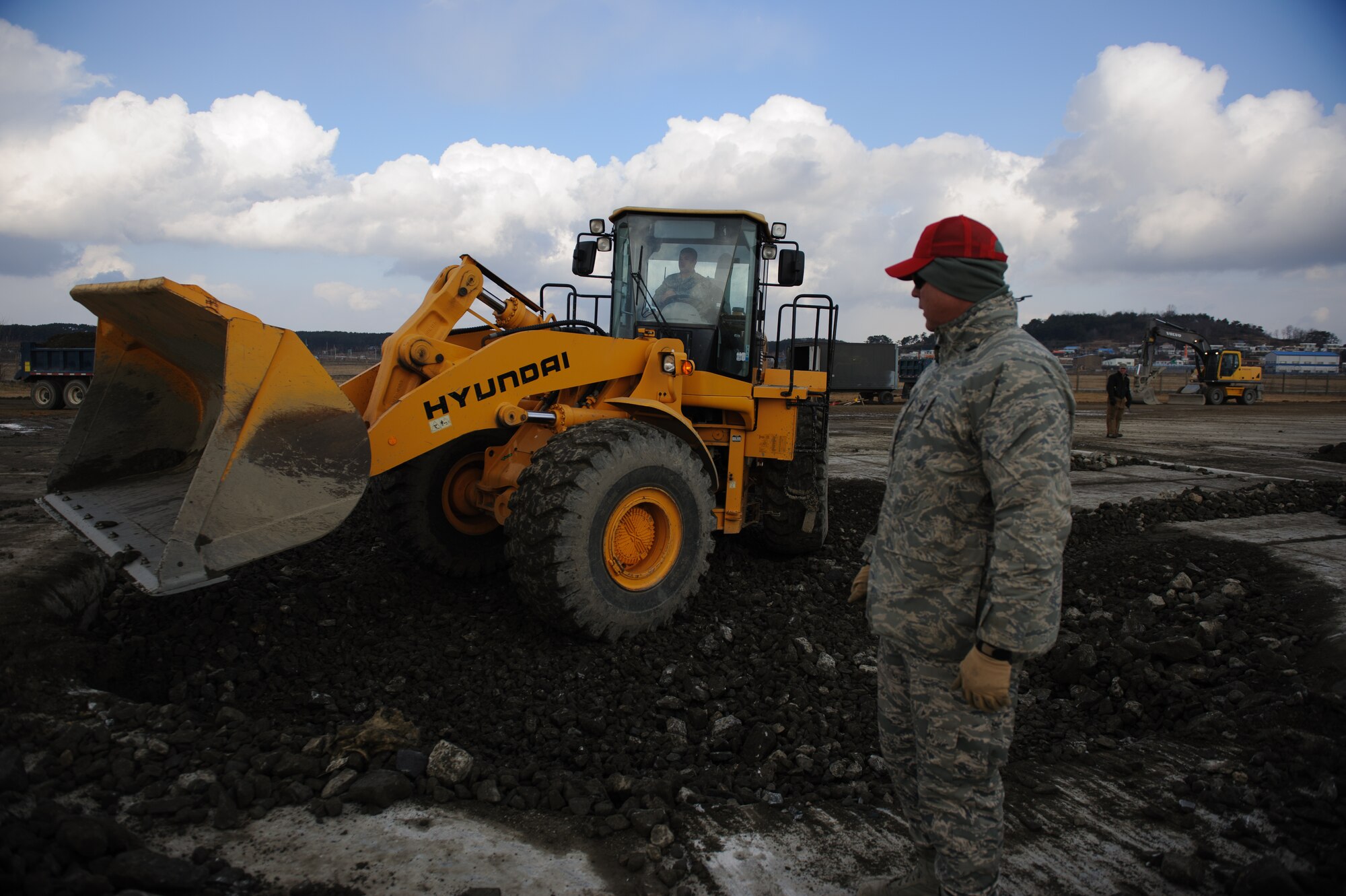 Master Sgt. William Webb, Detachment 1, 554 RED HORSE, watches an 8th Civil Engineer Squadron Airman flatten rocks during a training Silver Flag exercise at Kunsan Air Base, Republic of Korea, Dec. 19, 2013. Members from Detachment 1 554 RED HORSE came to Kunsan to train and develop civil engineer Airmen during the week long Silver Flag exercise. (U.S. Air Force photo by Senior Airman Armando A. Schwier-Morales/Released)