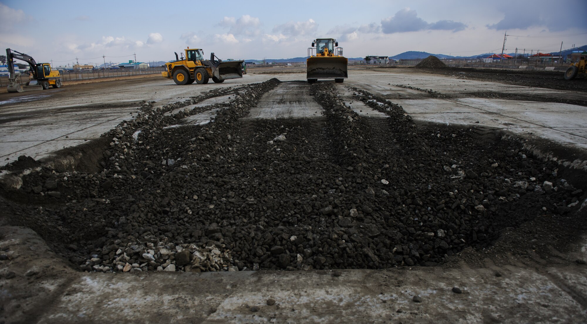 Eighth Civil Engineer Squadron Airmen fill a crater during a training Silver Flag exercise at Kunsan Air Base, Republic of Korea, Dec. 19, 2013. Members from Detachment 1 554 RED HORSE came to Kunsan to train and develop civil engineer Airmen during the week long Silver Flag exercise. (U.S. Air Force photo by Senior Airman Armando A. Schwier-Morales/Released)