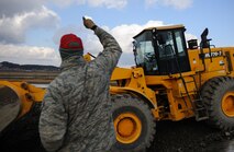 Master Sgt. William Webb, Detachment 1, 554 RED HORSE, signals to Staff Sgt. Souridet Thongrivong, 8th Civil Engineer Squadron, during an Airfield Damage Repair exercise at Kunsan Air Base, Republic of Korea, Dec. 19, 2013. Members from Detachment 1 554 RED HORSE came to Kunsan to train and develop civil engineer Airmen during the week long Silver Flag exercise. (U.S. Air Force photo by Senior Airman Armando A. Schwier-Morales/Released)